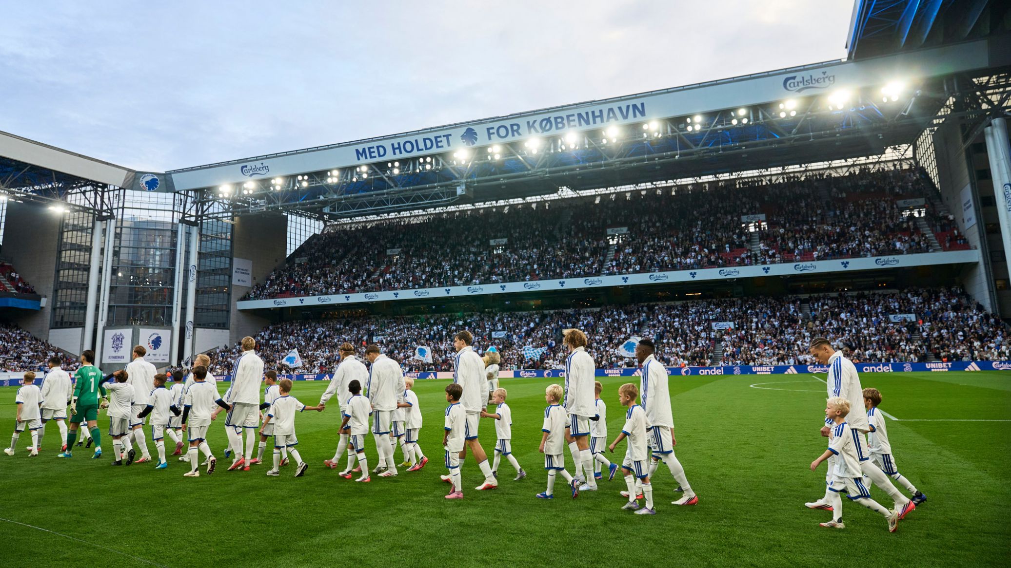 Spillerne går på banen med indmarchbørn fra Klub Leo